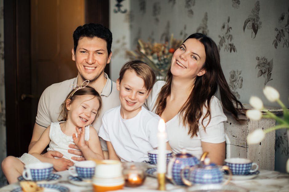 Cheerful family of four enjoying a warm and cozy teatime at home, surrounded by love and laughter.